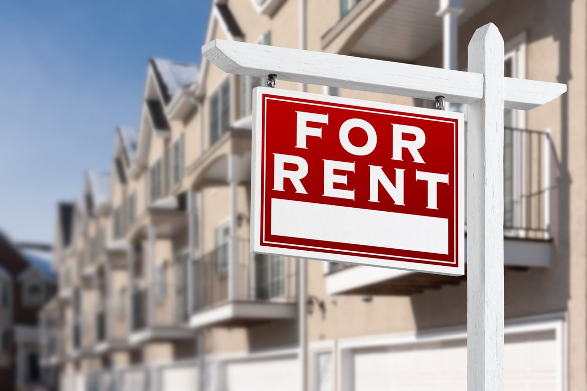 Total cost of a commercial lease showing a row of commercial units and a to let sign