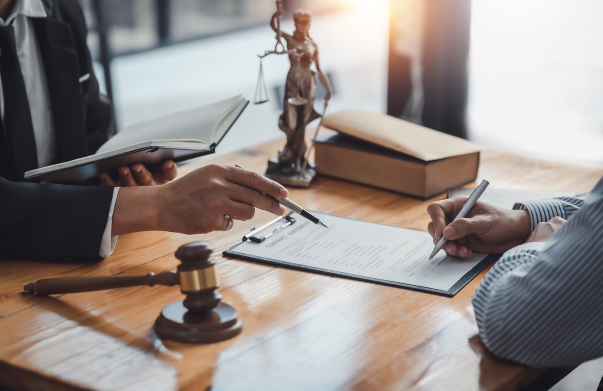 Legal documents being signed, representing litigation and dispute resolution in commercial lease matters