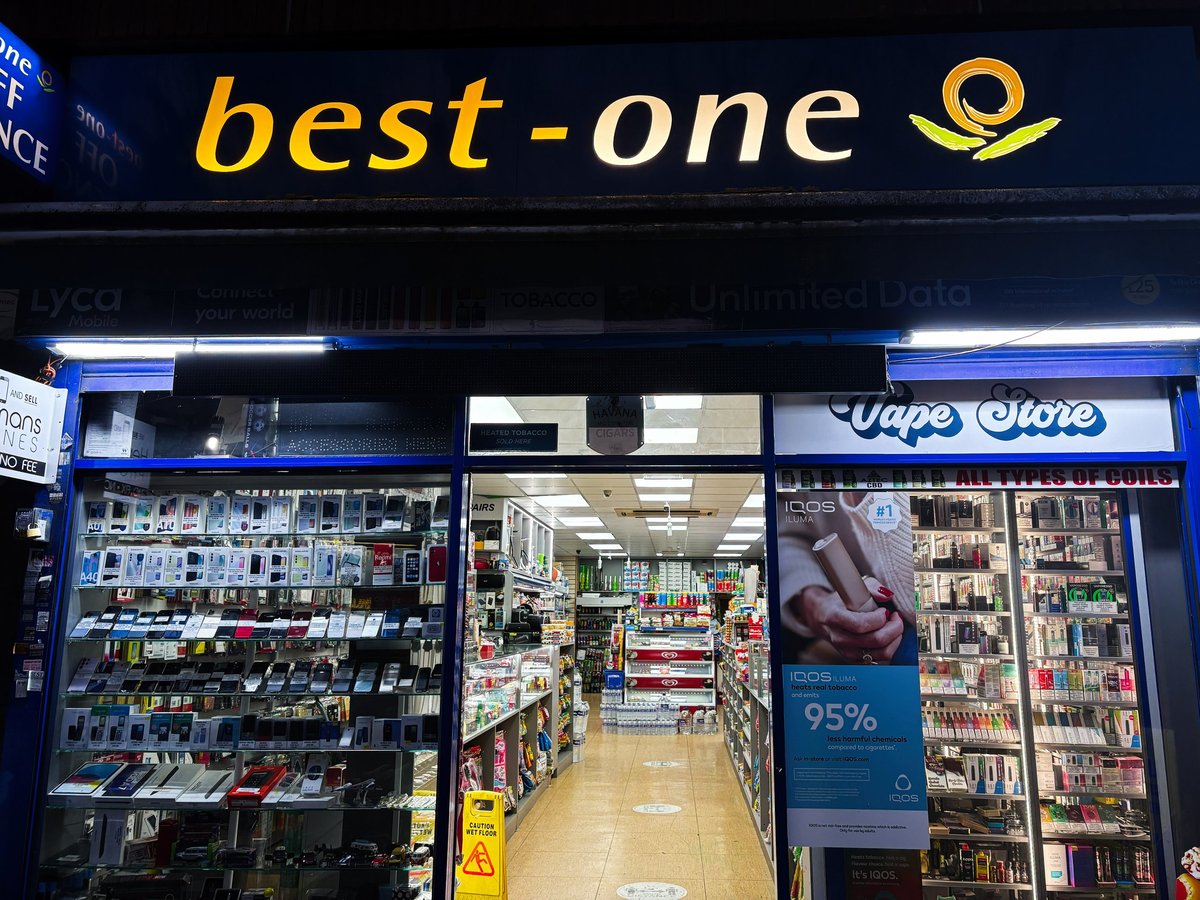 London UK vape shop storefront with illuminated signage showcasing electronics and vape products