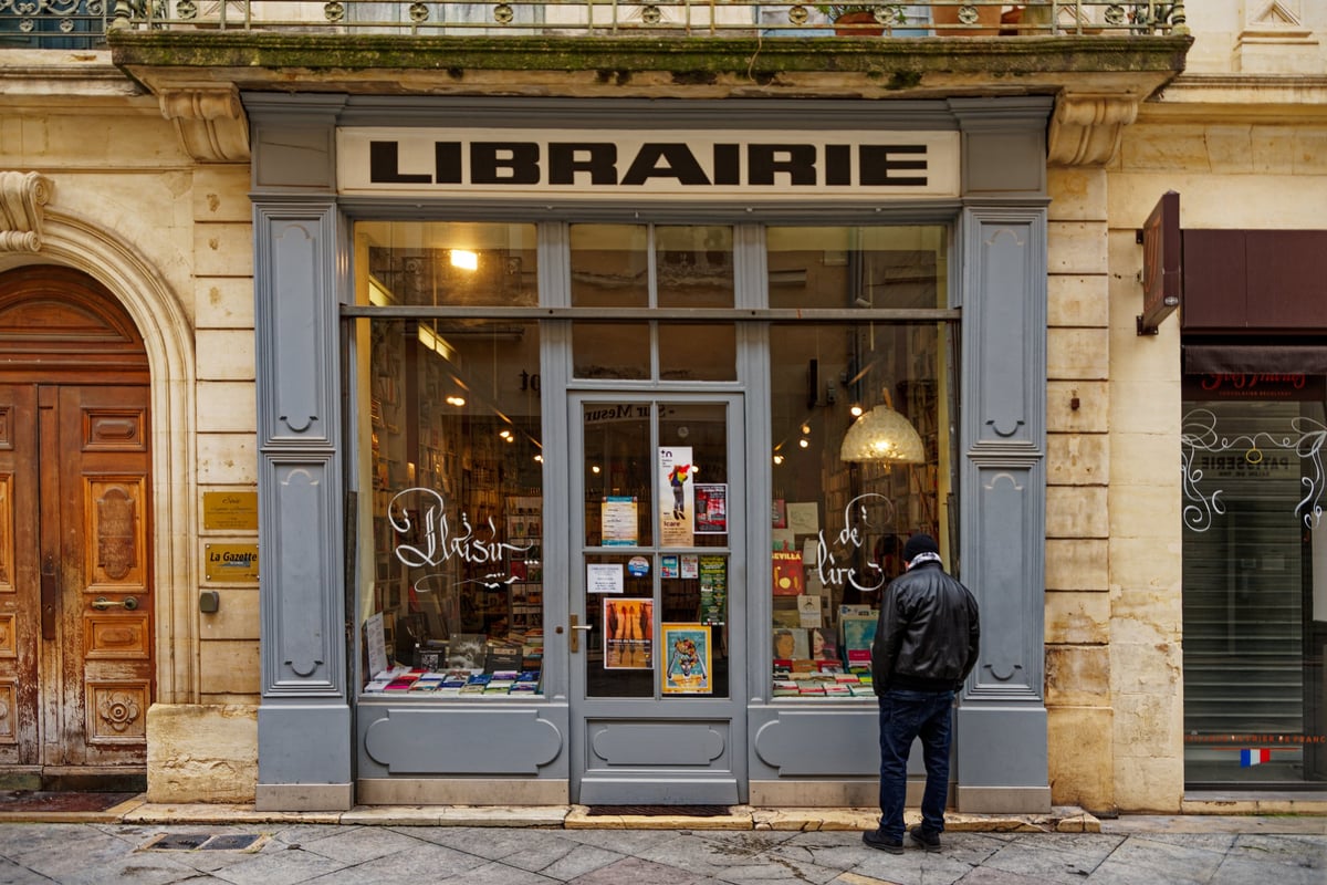Person looking into an old bookstore