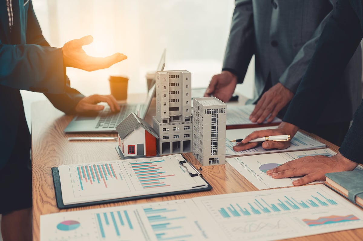 Commercial landlord and business tenant discussing lease terms in professional office meeting