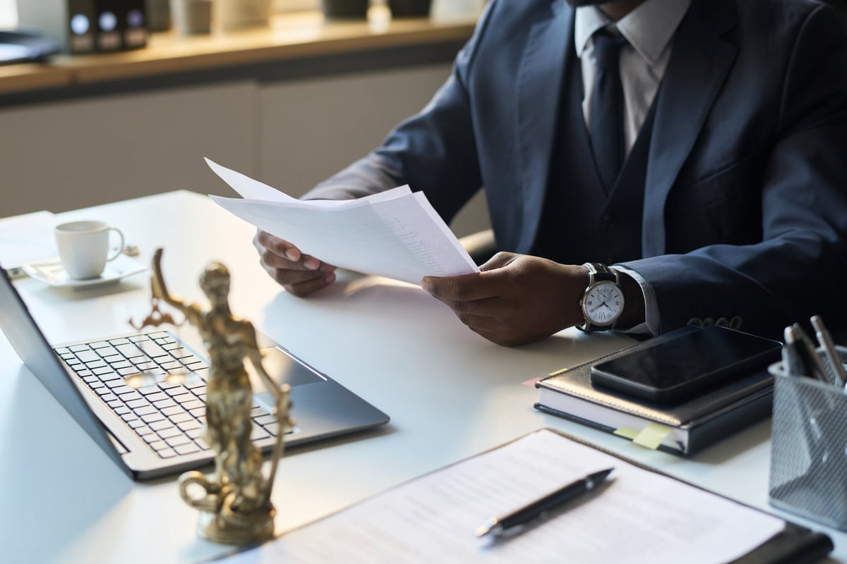 Commercial solicitor reviewing lease variation agreement documents with client at desk