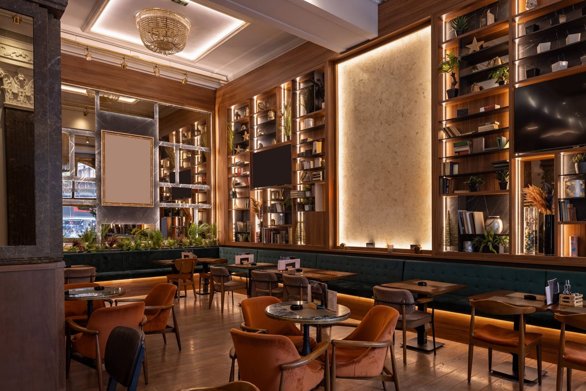 Stylish double-level restaurant with wooden décor, chandeliers, and warm ambient lighting