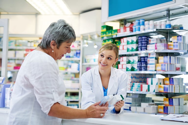 Commercial lease solicitors for pharmacies reviewing pharmacy premises lease documents with independent pharmacy owners and pharmacy contractors in a modern pharmacy setting across England and Wales